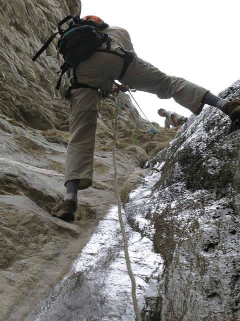 A volunteer makes his way up a wall